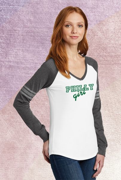 Woman wearing long sleeve cotton tee shirt imprinted with Philly Girl logo